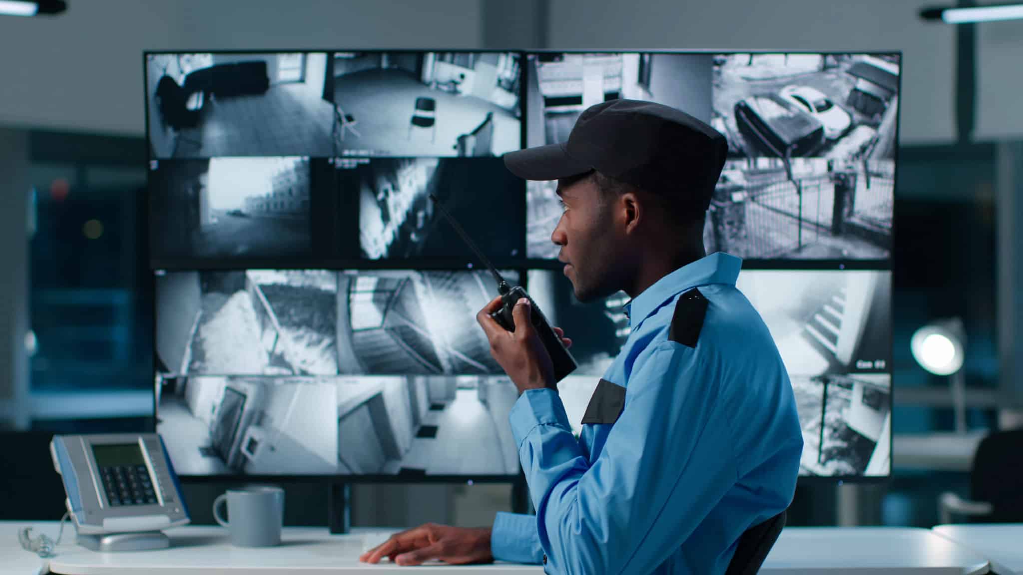 Security guard overseeing large indoor cannabis cultivation facility.